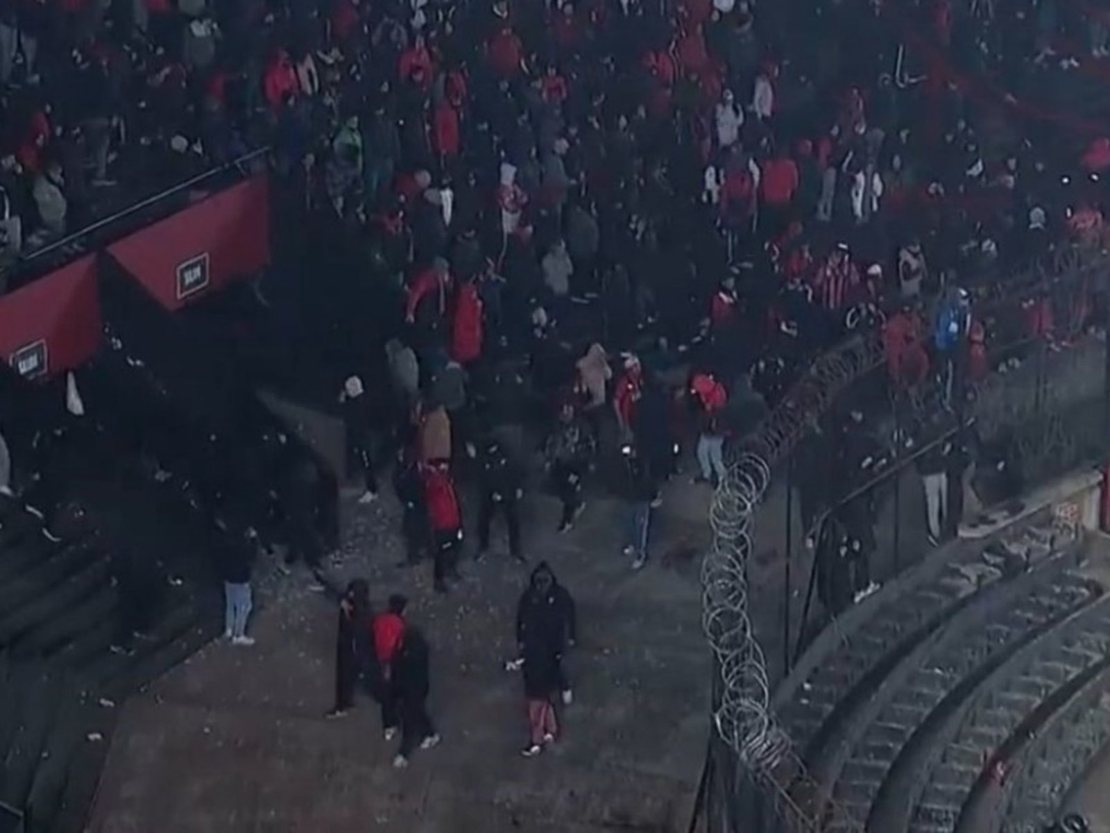 proyectiles de los hinchas, tiros de la policía y los jugadores atrincherados en el medio del campo